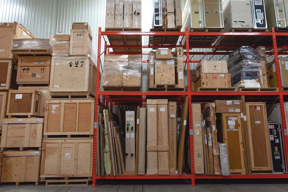 orange storage racking with crates, inside of a warehouse.