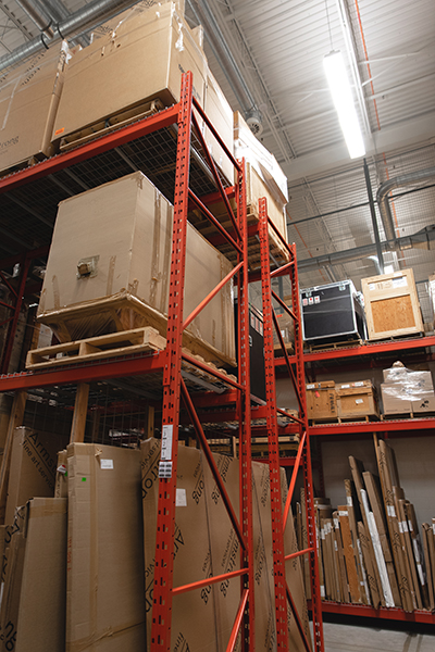 orange storage racking with crates, inside of a warehouse.
